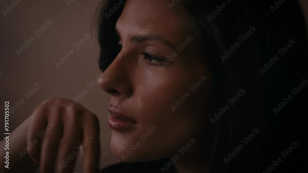 Beautiful attractive woman sitting on sofa , flirting , posing and looking into and away from camera. Fashion concept Beautiful attractive woman sitting on sofa , flirting , posing and looking into and away from camera. Fashion concept