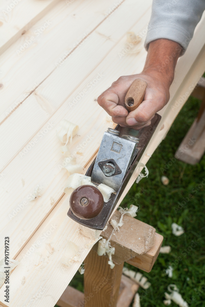 Working with hand plane. Joiner's (carpenter's) tool.