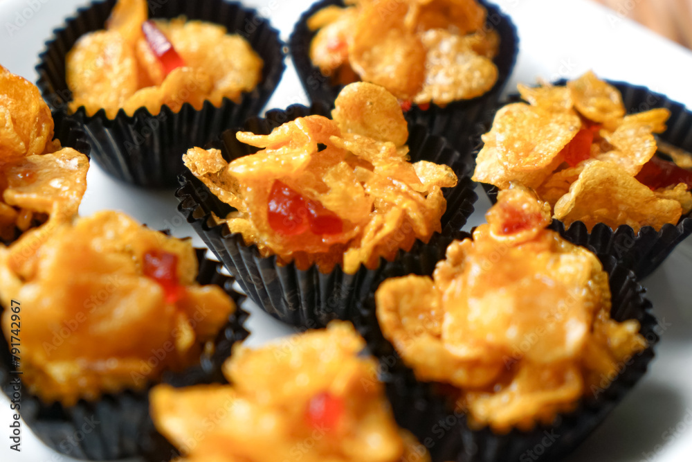 Honey Cornflakes (Cornflakes Madu) a popular cookies in Malaysia during celebration of Eid Mubarak (Hari Raya) on selective focus Honey Cornflakes (Cornflakes Madu) a popular cookies in Malaysia during celebration of Eid Mubarak (Hari Raya) on selective focus