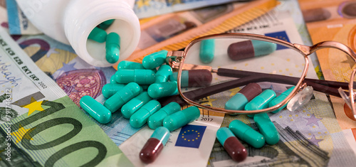 Medical pills, tablets in blister with Euro currency banknotes, concept of high medical expenses