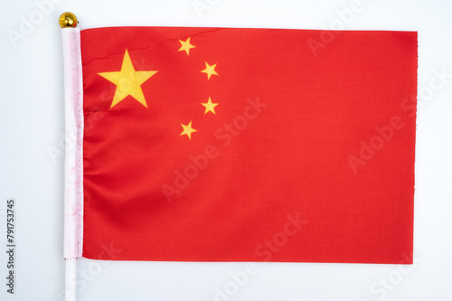A China flag against white background. The national flag of the People's Republic of China is red in color, rectangular in shape, with five stars.