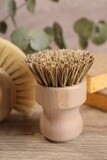 Small cleaning brush on wooden table, closeup