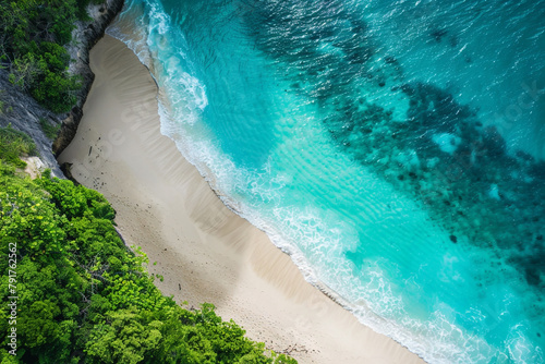 Aerial view of a secluded beach with turquoise waters and soft white sand