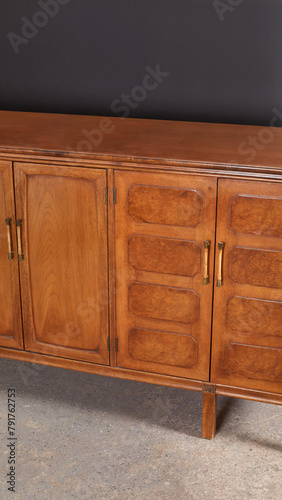 Unique vintage wooden credenza. Art Deco revival sideboard furniture piece. Close-up product photograph.