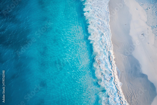 Aerial view of a serene beach with soft white sand and azure waters