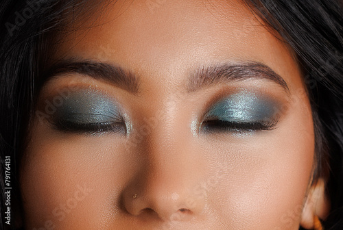 Close eyes with bold eye makeup