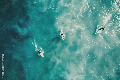 A group of surfers flying on their boards in the ocean, aerial view