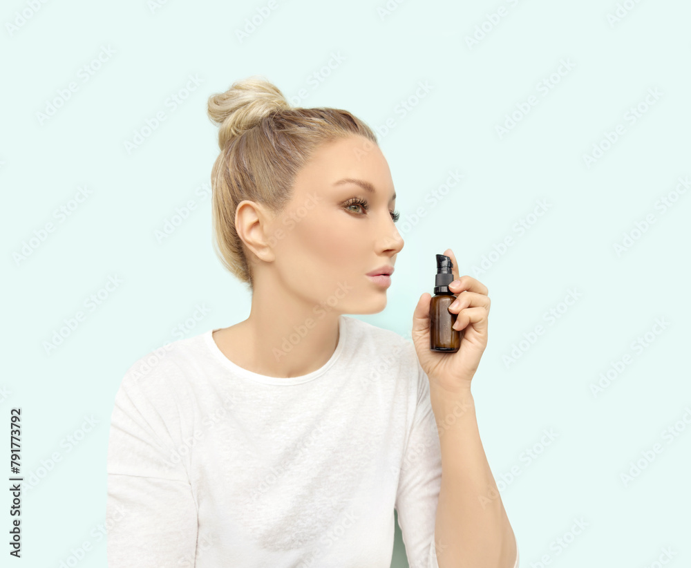 woman applying serum, lotion to her face woman applying serum, lotion to her face