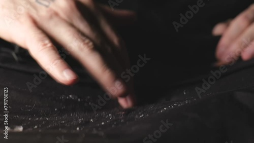 Water dripping onto waterproof fabric. Water jet on water resistant jacket. drops of water on water-repellent clothing