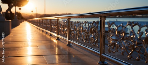 Metal railing on the embankment of the river at sunset. photo