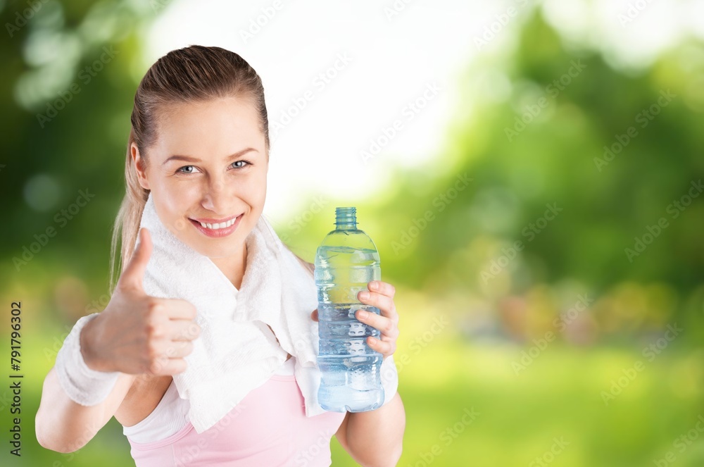 An exhausted and sweaty sporty person drink water An exhausted and sweaty sporty person drink water
