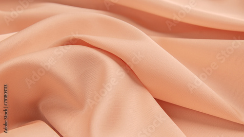 Folds of clothes close-up, concept color of the year 2024 Peach Fuzz.