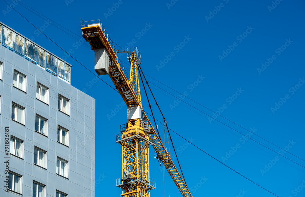 A tower crane on the construction of a high-rise building. A tower crane on the construction of a high-rise building.