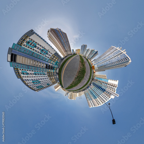 abstract swirling tiny planet spherical panorama of multi-storey buildings of skyscrapers of a residential complex in the form of a butterfly in blue sky