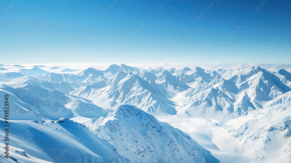 A serene panoramic vista showcases endless snow-blanketed mountains under a clear blue sky, invoking a sense of calm and isolation