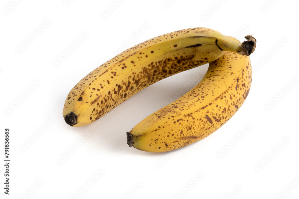 Two very ripe and spotted yellow and brown bananas on a white background