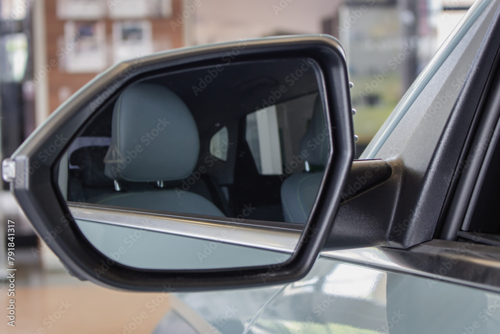 Rear view mirror. New car interiors. Elegant car with grey seat. Part of vehicle. Car design. Business class auto design.