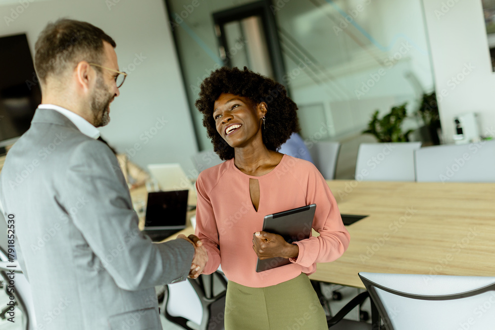 Professional handshake between colleagues in a modern office setting during daylight hours Professional handshake between colleagues in a modern office setting during daylight hours
