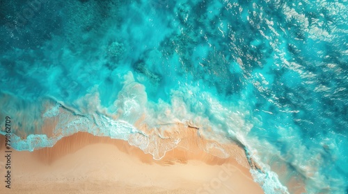 Aerial view of a sandy beach with clear blue water textures