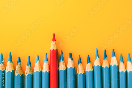 A row of blue pencils with a red pencil in the middle