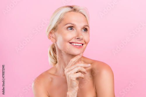 Photo of charming senior woman nude shoulders touch soft pure perfect skin anti wrinkles effect cream isolated on pink color background photo