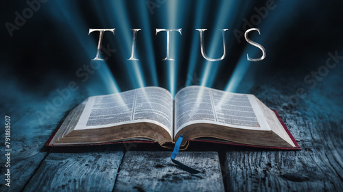The book of Titus. Open bible with blue glowing rays of light. On a wood surface and dark background. Related to this book: Leadership, Instruction, Sound Doctrine, Good Works, Order, Integrity photo