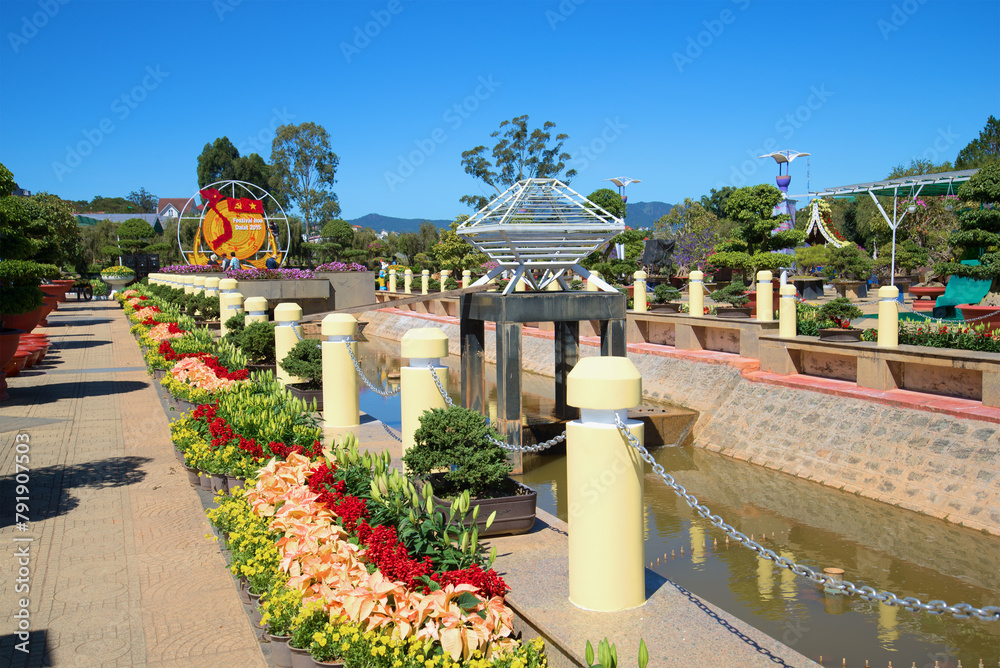 The avenue with lilies in the flower park of Da Lat - obrazy, fototapety, plakaty 