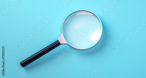 Magnifying glass from above on blue.
