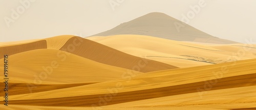   A group of mountains in the distance with sand dunes preceding them in the foreground © Jevjenijs