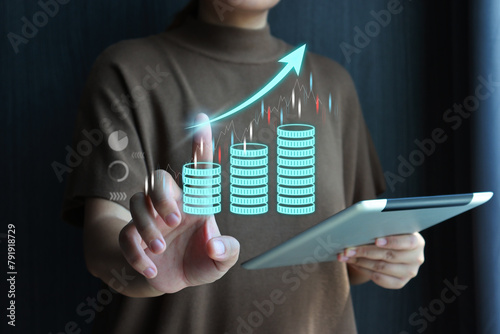 Businesswoman touching a virtual stack of coins and arrow pointing uptrend. Forex trading, stock market, financial investment, retirement fund, sustainability investor.