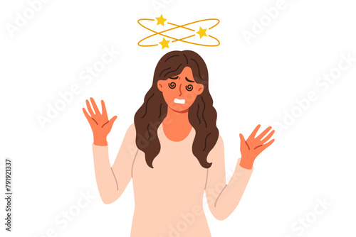 Woman feels dizzy caused by hangover or intracranial pressure, stands with stars above head. Problem of dizzy or dizziness in girl experiencing problems with well-being and health. photo