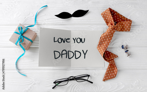 Father's day concept top view card,gift box and tie. Male accessories.
