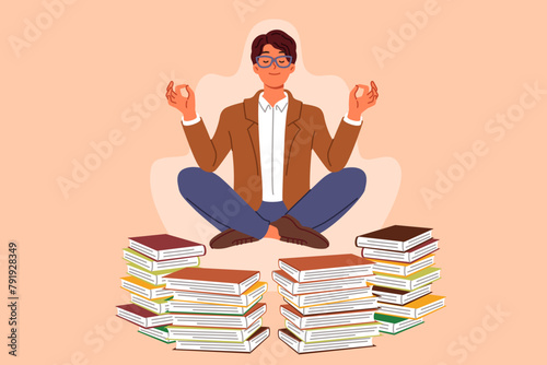 Man does yoga and meditation, taking break from reading books, levitating in lotus position to restore energy. Guy will become interested in yoga practices that help maintain good mental health