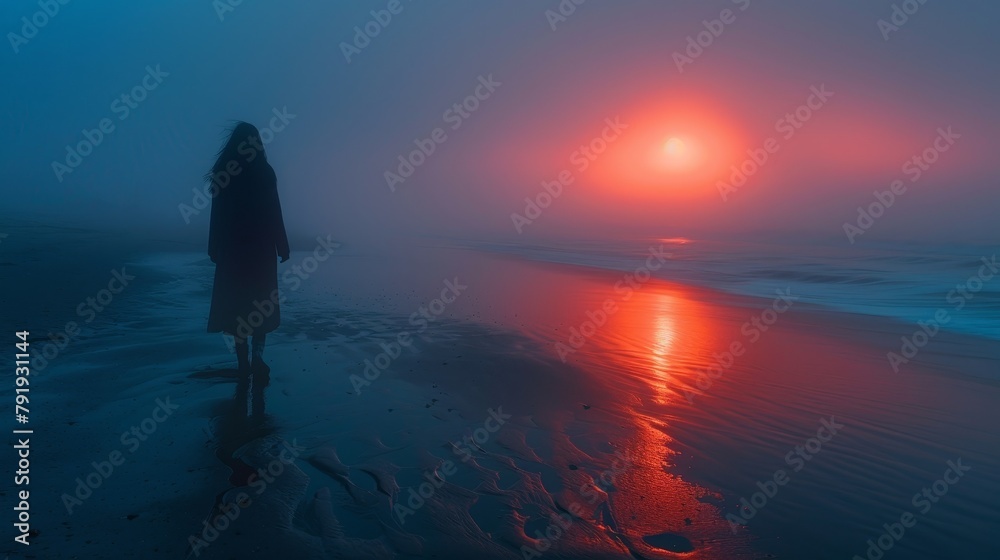 A woman reflects in solitude on a quiet beach at dawn, bathed in soft morning light
