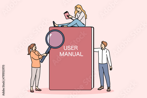 Book with user manual next to miniature people reading tips and rules for using product. Textbook with inscription user manual on cover is intended for teaching independent use of equipment