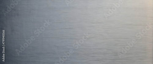 A close-up image of a metallic surface with a brushed texture that reflects the light with subtle variations photo