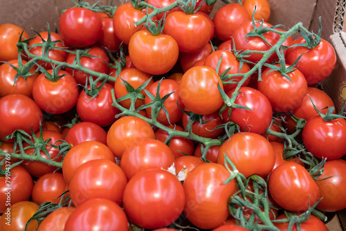 A lot of red tomatoes are sold in a supermarket