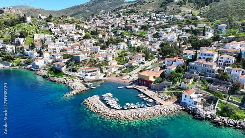 Aerial drone cinematic video of small picturesque seaside village and harbour of Kaminia located near main village of Hydra island accessible by footpath, Saronic gulf, Greece photo