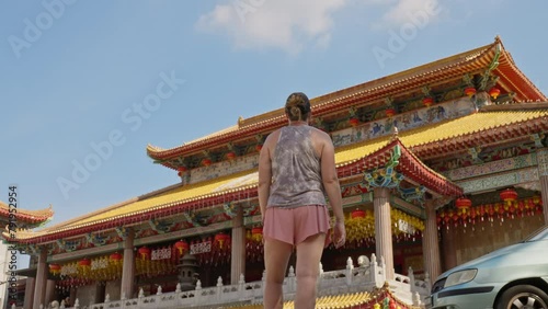 Parallax movement of woman looking at the majestic Kek Lok Si Temple Shrine Hall in George Town, Penang island, Malaysia