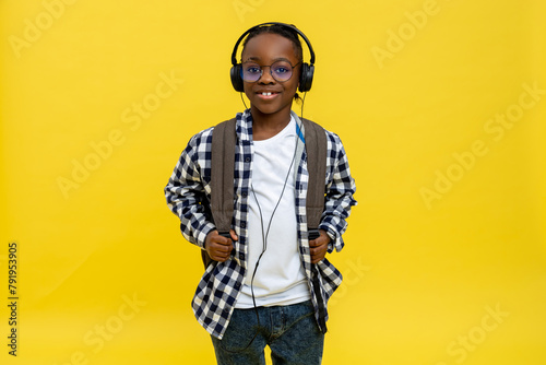 Cute african american schoolboy in checkered tshirt looking happy photo