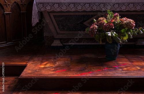 Flowers at the foot of the church altar. Photography taken in France