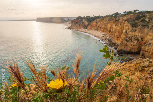The rugged coastline at dawn, overlooking beach near Lagos in the Algarve, Portugal