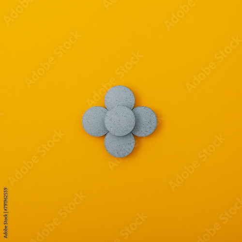 Light blue pigments in tablets on yellow background. Dyes or Food additives for coloring food products, and also decorating Easter eggs