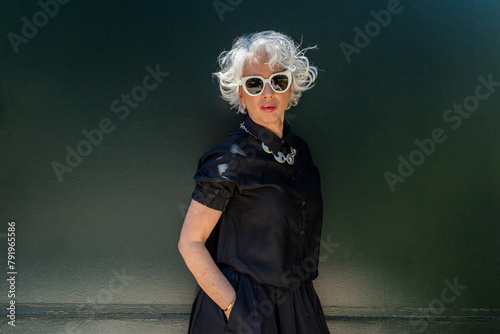 Portrait of a white-haired woman in her sixties dressed elegantly in fashion