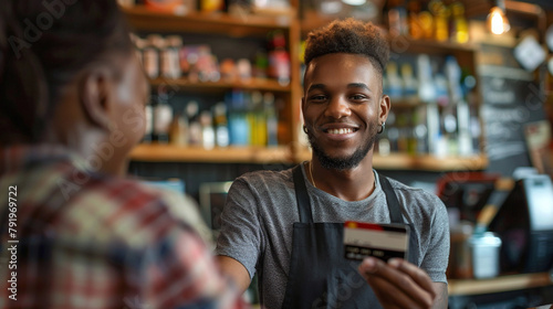 Joyful Small Business Owner Accepting Payment Via Credit Card From A Satisfied Patron photo