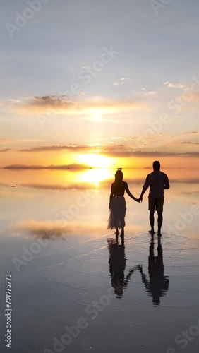 Wallpaper Mural Salar de Uyuni in Bolivia during sunset. Aerial image taken with a drone. Uyuni Salt Flats. Altiplano, Bolivia. Rainy Season. Tunupa Volcano. Clouds Reflection on Water in Lake Surface. Vertical video Torontodigital.ca