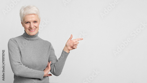 Elderly woman pointing to her right side photo
