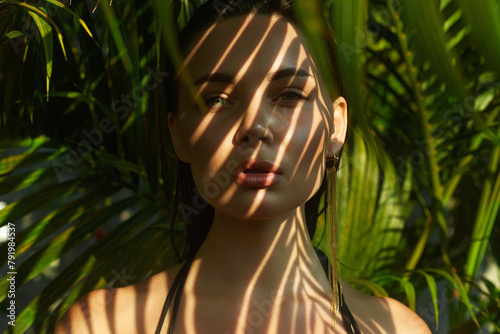 beautiful summer girl. young sexy woman in bikini under palm tree