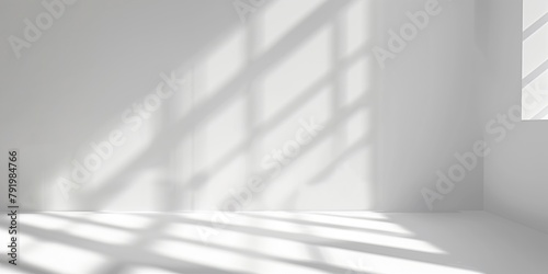 Minimalistic white room interior with sunlight casting soft shadows through window blinds