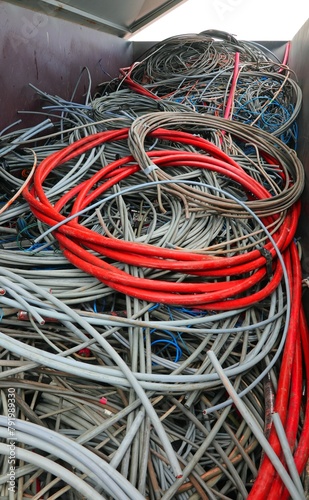 High-voltage power cable and other copper wires in recycling container at the authorized landfill photo